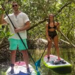 friends standing and paddling through sarasota kayak rental Mangrove Tunnels