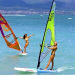 couple learning to windsurf miami