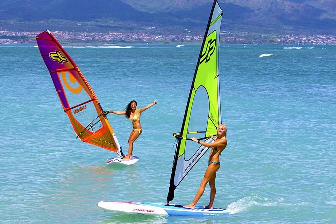 couple learning to windsurf miami