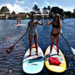 girls standing on a paddle board rentals in fort lauderdale