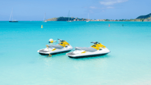 photograph of unused jet skis in blue water