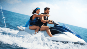 photograph of couple on a waverunner in water