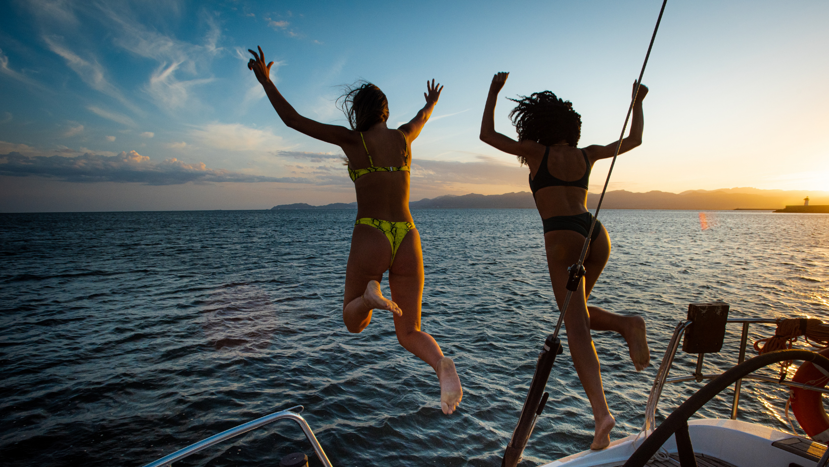 girls jumping from a crystal river boat rental