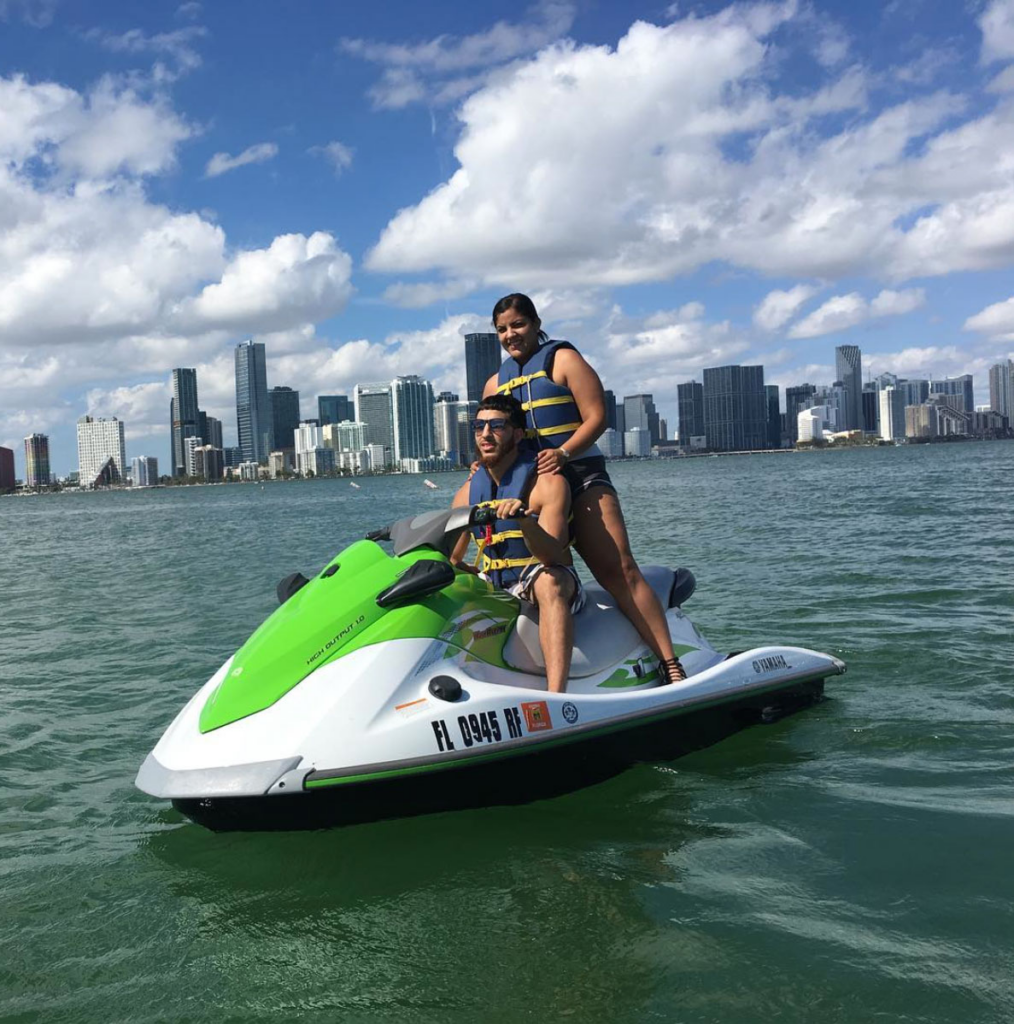Two people on a jet ski with life jackets on