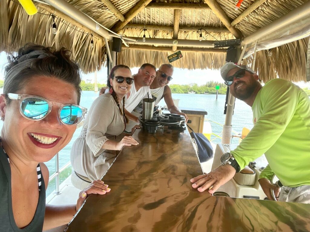 group under the shade in a tiki bar in key largo
